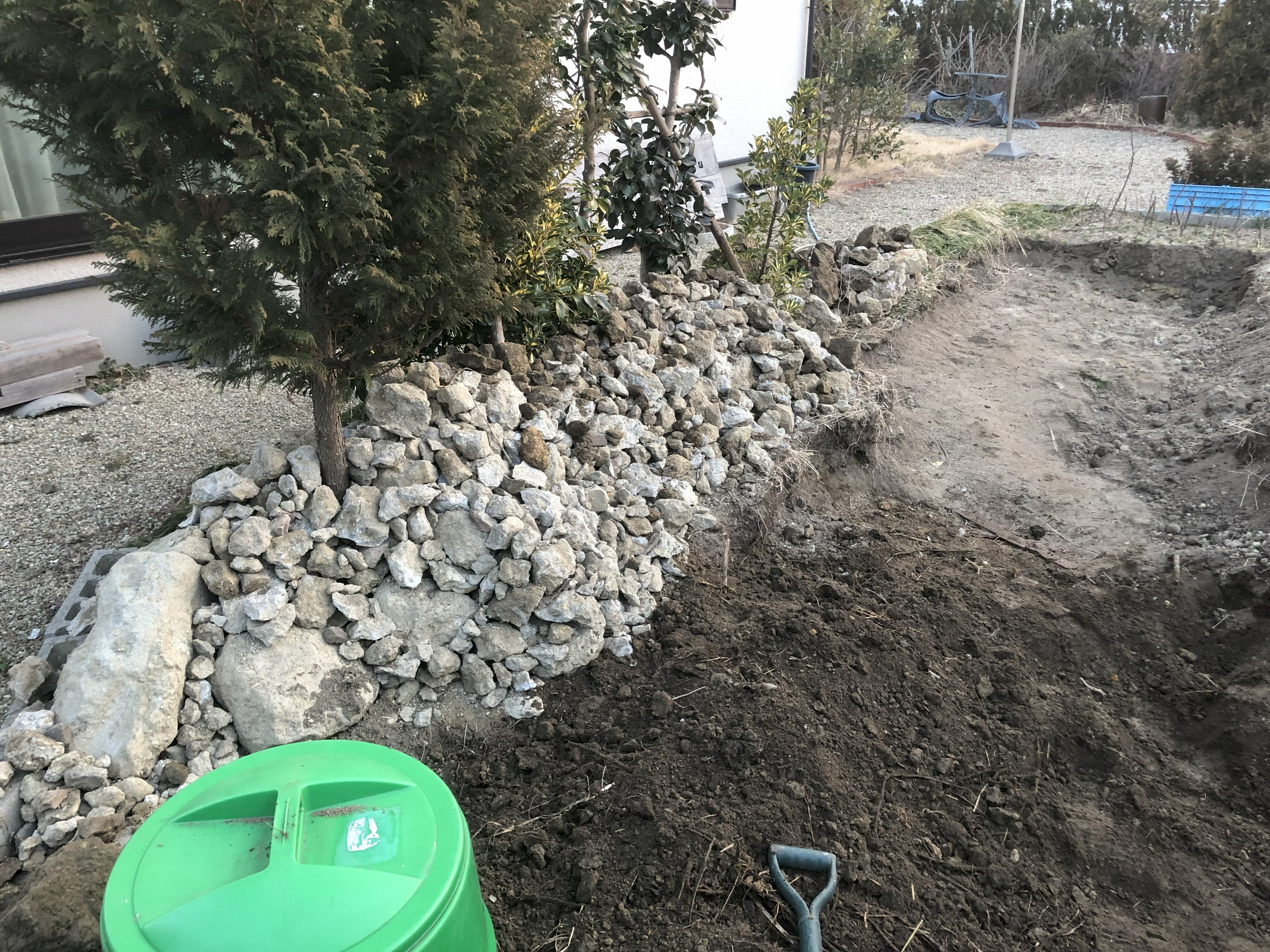 Pile of broken rocks stacked on the left after excavation
